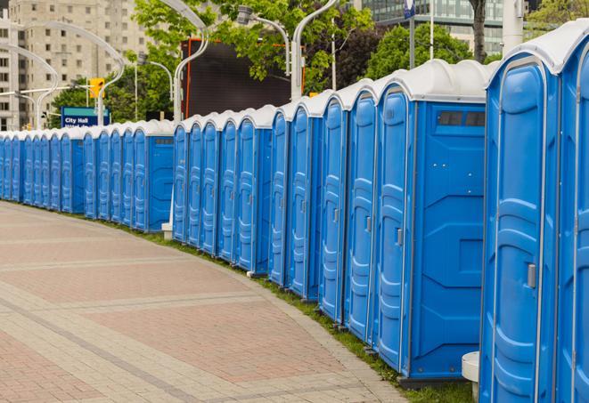 a row of portable restrooms at an outdoor special event, ready for use in Bloomington